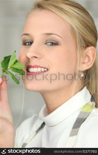 woman smelling a mint leave