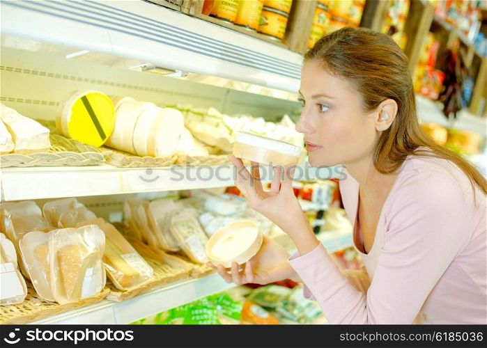 Woman smelling cheese