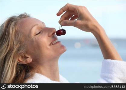 Woman smelling cherries