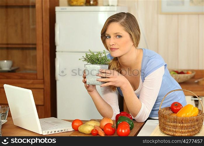 Woman smelling herbs in the kitchen
