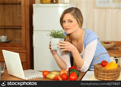 Woman smelling herbs in the kitchen