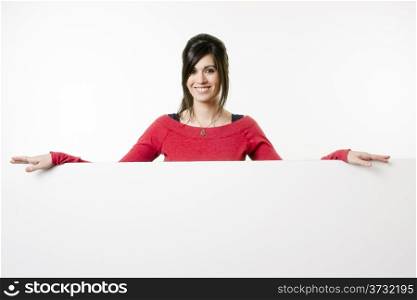 Woman smiles at she stands in between white spaces