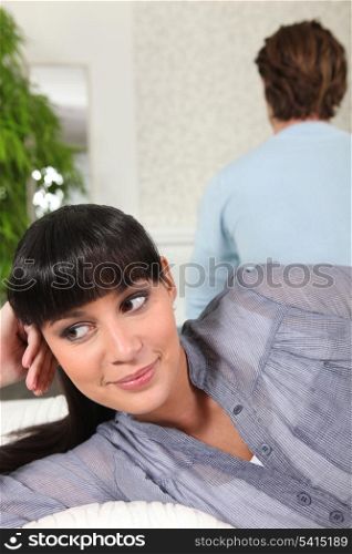 Woman smiling behind her partner&rsquo;s back