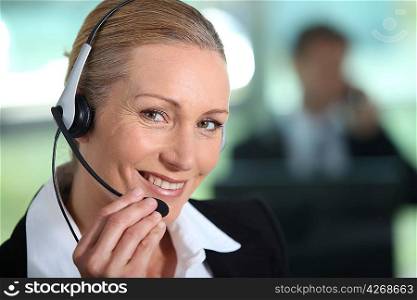 Woman smiling holding headset