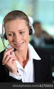 Woman smiling holding headset