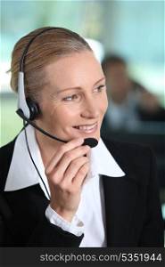 Woman smiling holding headset