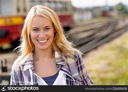 Woman smiling looking at camera vacation railroad tourist trip beautiful
