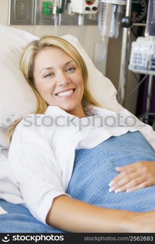 Woman Smiling,Lying In Hospital Bed