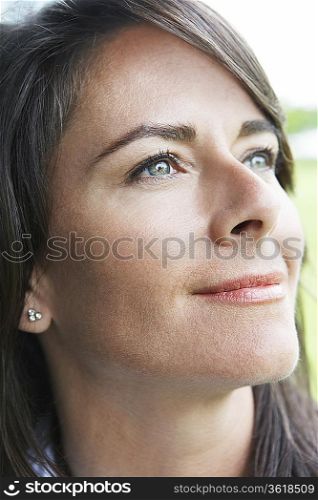 Woman smiling outdoors, close-up