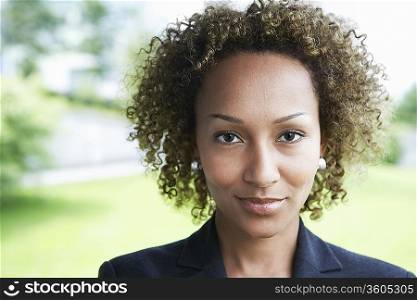 Woman smiling, outdoors, close-up, portrait