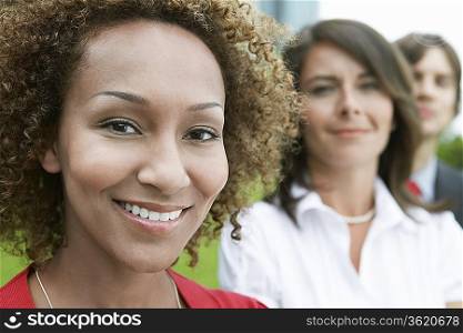 Woman smiling outdoors, close-up, portrait