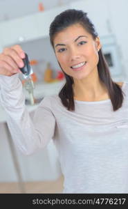 woman smiling showing new car keys indoors