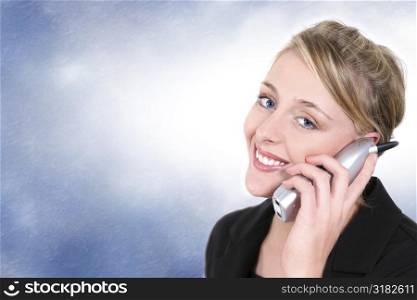 Woman smiling, talking on cordless home phone.