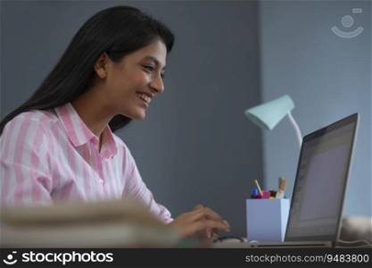 Woman smiling while working on her project