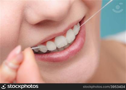 Woman smiling with dental floss.. Oral hygiene and health care. Smiling women use dental floss white healthy teeth.