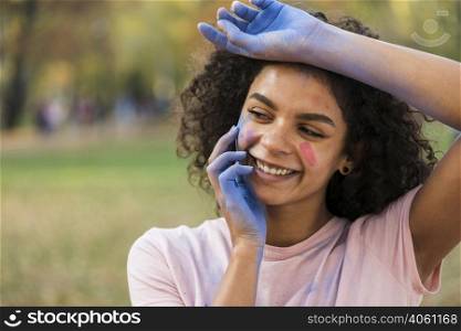 woman smiling with hands covered blue powder