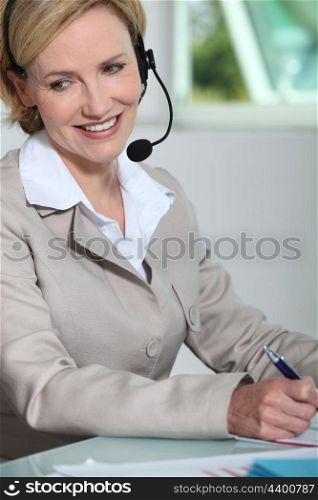 Woman smiling with headset.