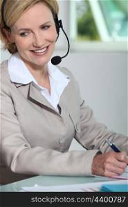 Woman smiling with headset.