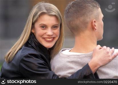 Woman Smiling With Her Arm Around Man