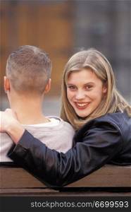 Woman Smiling With Her Arm Around Man