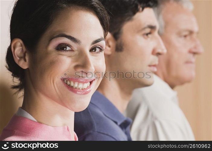 Woman smiling with her family beside him