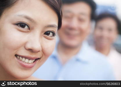 Woman smiling with her parents, portrait