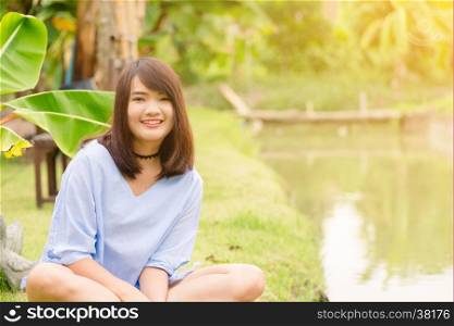 Woman smiling with perfect smile and white teeth in a park and looking at camera