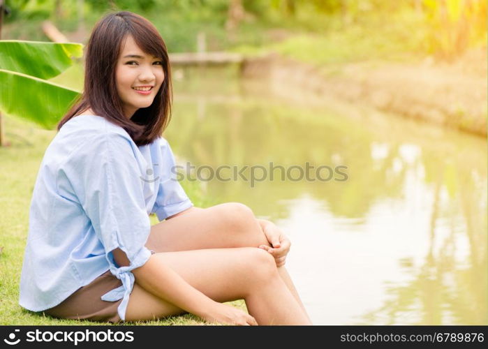 Woman smiling with perfect smile and white teeth in a park and looking at camera