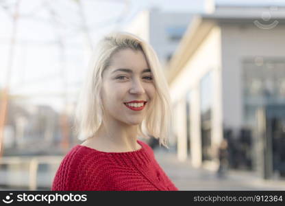 Woman smiling with perfect smile and white teeth outdoors and looking at camera