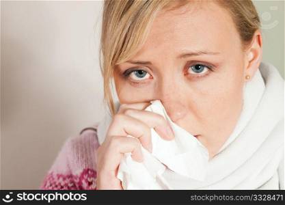 Woman sneezing, having a flu and looking feverish