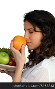 Woman sniffing orange