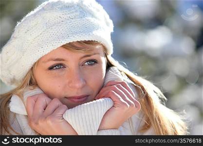 Woman snuggling up to her warm clothing