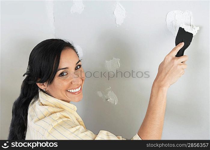 Woman Spackling Wall
