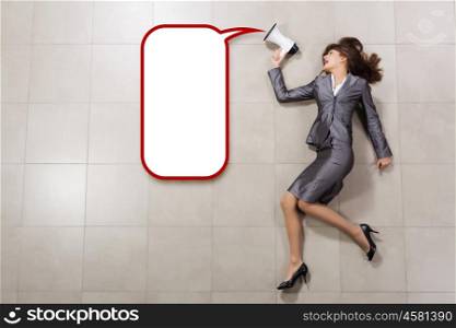 Woman speaker. Attractive businesswoman screaming in megaphone. Place for text