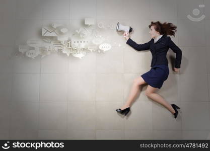 Woman speaker. Funny businesswoman lying on floor businesswoman holding megaphone