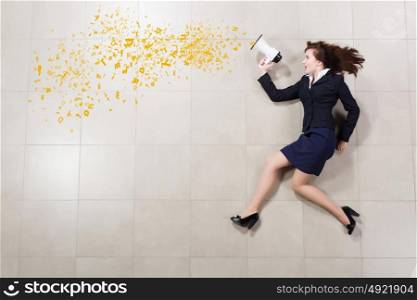 Woman speaker. Funny businesswoman lying on floor businesswoman holding megaphone