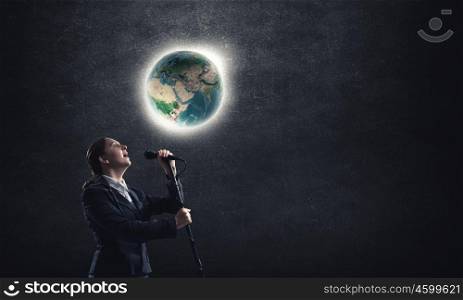 Woman speaker. Woman reporter with microphone gesturing with hand. Elements of this image are furnished by NASA