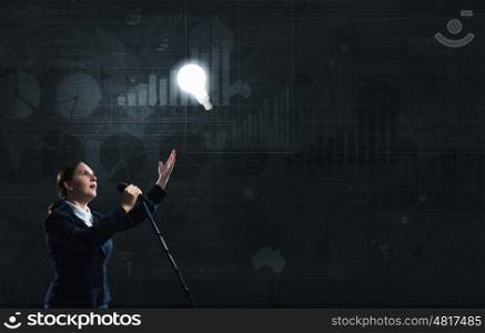 Woman speaker. Woman reporter with microphone gesturing with hand