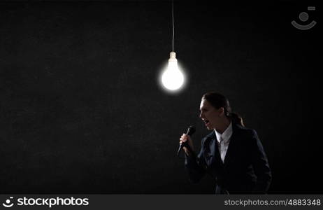 Woman speaker. Woman reporter with microphone gesturing with hand