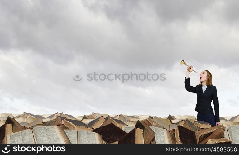 Woman speaking in horn. Young businesswoman in suit proclaiming something in horn