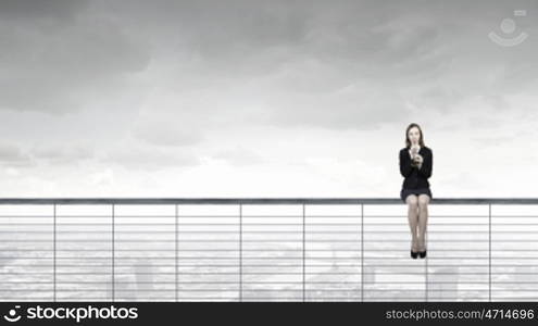 Woman speaking in horn. Young businesswoman in suit proclaiming something in horn