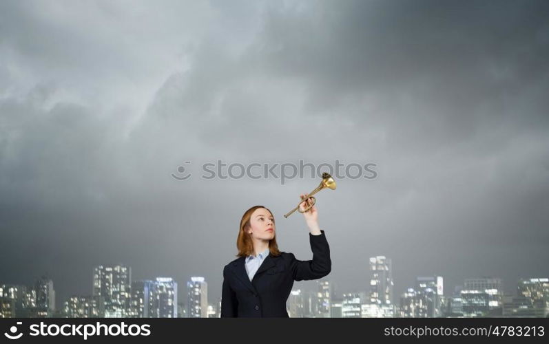 Woman speaking in horn. Young businesswoman in suit proclaiming something in horn