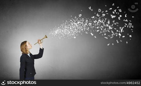 Woman speaking in horn. Young businesswoman in suit proclaiming something in horn