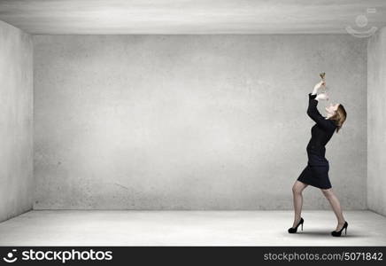 Woman speaking in horn. Young businesswoman in suit proclaiming something in horn