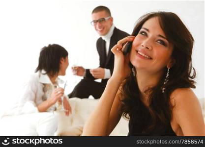 woman speaks on a mobile phone and happy friends