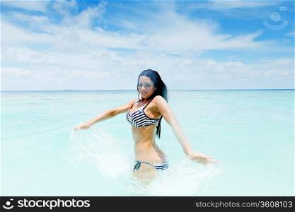 Woman splashing in sea