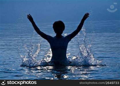 Woman splashing in water