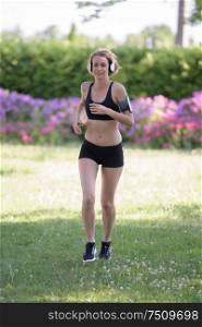 woman sport running on hill for fitness with blossoming trees