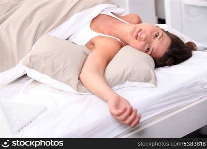 Woman sprawled in bed