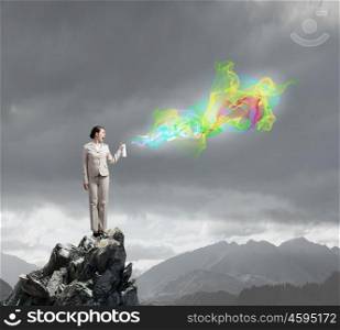 Woman spraying colors. Young businesswoman in glasses using spray balloon